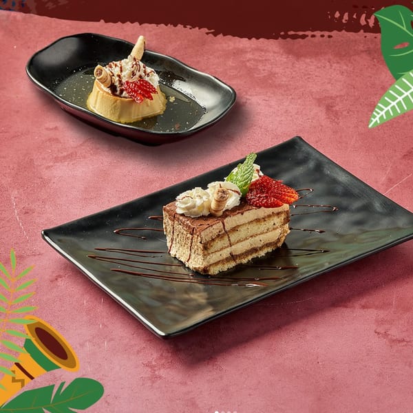 Two Dominican desserts: a flan with whipped cream and a layered cake with strawberries and mint.
